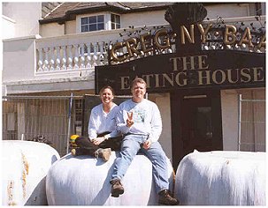 Kim and Fred pose on top of the haybales protecting the Creg Ny Baa from errant motorcycle drivers